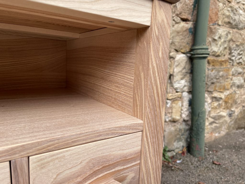 "Chaffinch" bedside cabinet made by Iain Stirling of Chapelhill Fine Furniture. Close-up of inside of shelf cavity showing horizontal grain.