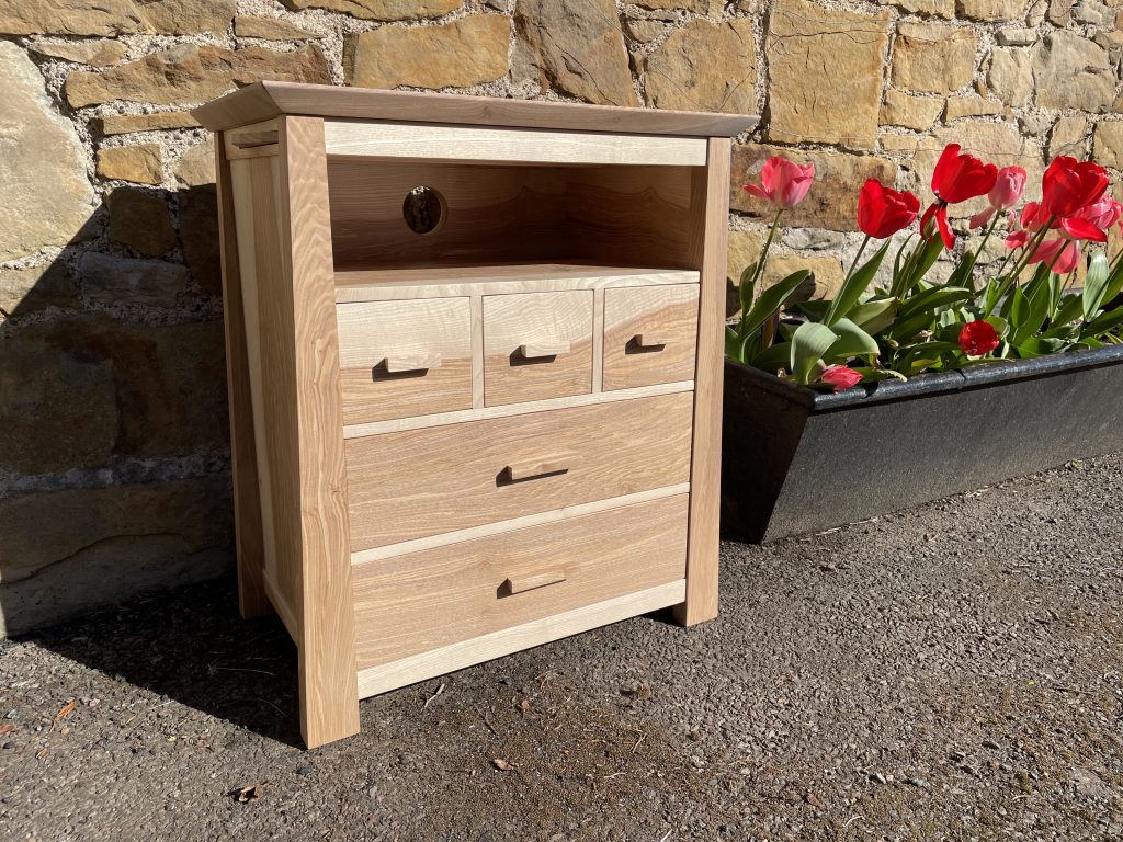 Picture of a "Chaffinch" Bedside Cabinet in olive ash.  Bespoke furniture made by Iain Stirling of Chapelhill Fine Furniture.