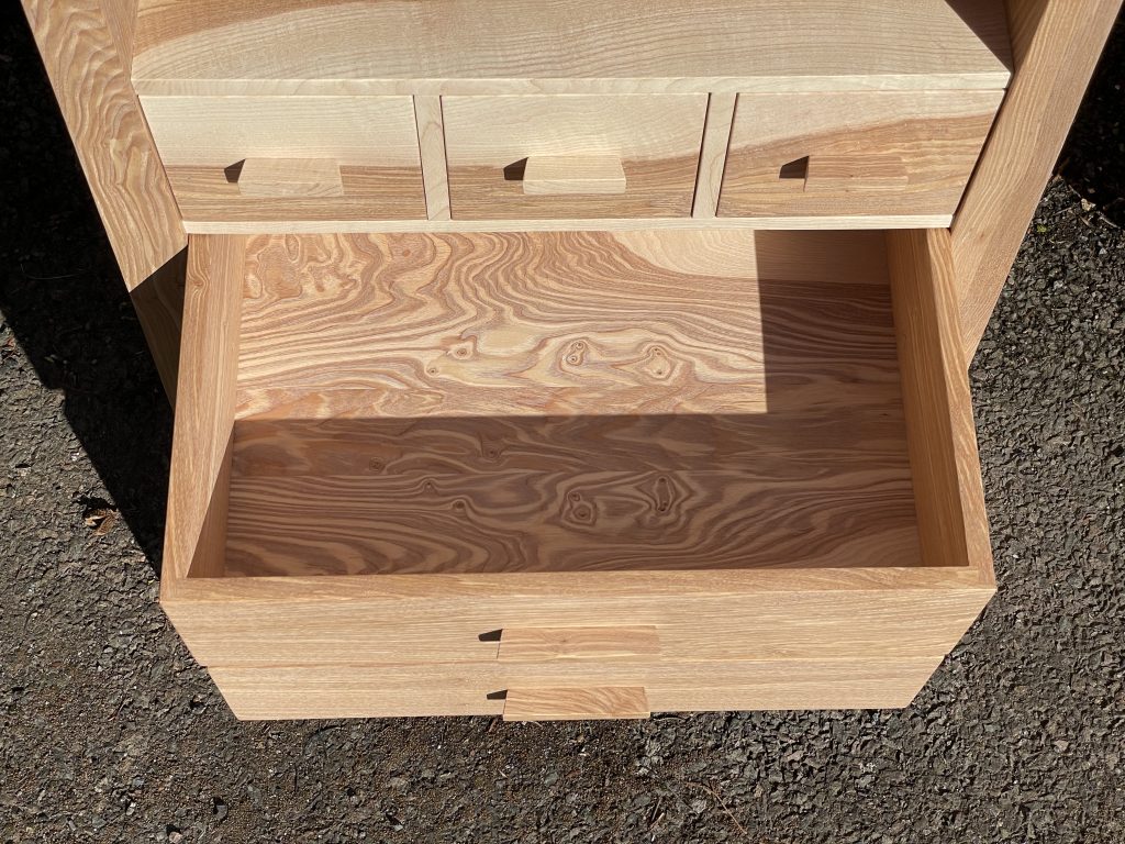 Picture of a "Chaffinch" Bedside Cabinet in olive ash.  Bespoke furniture made by Iain Stirling of Chapelhill Fine Furniture.