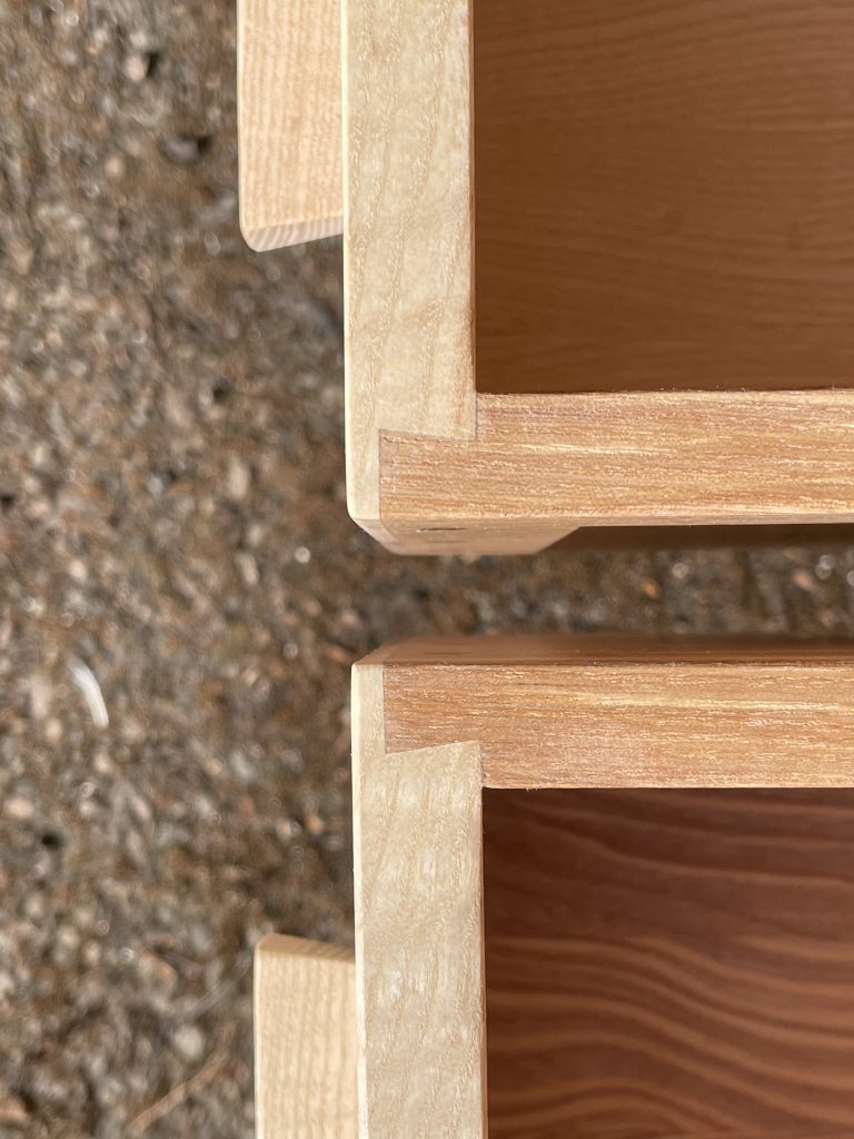 Picture of a "Chaffinch" Bedside Cabinet in olive ash.  Bespoke furniture made by Iain Stirling of Chapelhill Fine Furniture.