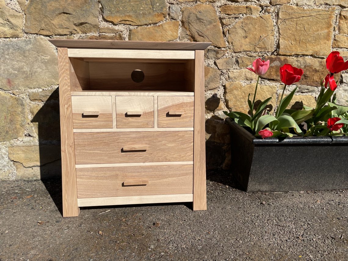Picture of a "Chaffinch" Bedside Cabinet in olive ash. Bespoke furniture made by Iain Stirling of Chapelhill Fine Furniture.