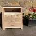 Picture of a "Chaffinch" Bedside Cabinet in olive ash. Bespoke furniture made by Iain Stirling of Chapelhill Fine Furniture.