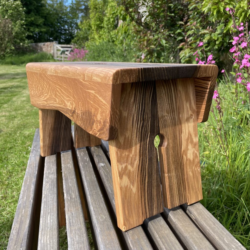 Scottish creepie stool in spalted olive ash, made by Chapelhill Fine Furniture.
