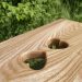 Scottish creepie stool made from Scottish elm with a double-heart pair of finger holes in the top surface, made by Chapelhill Fine Furniture.