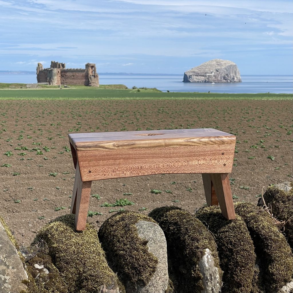 Scottish creepie stool in olive ash and sapele, made by Iain Stirling of Chapelhill Fine Furniture.