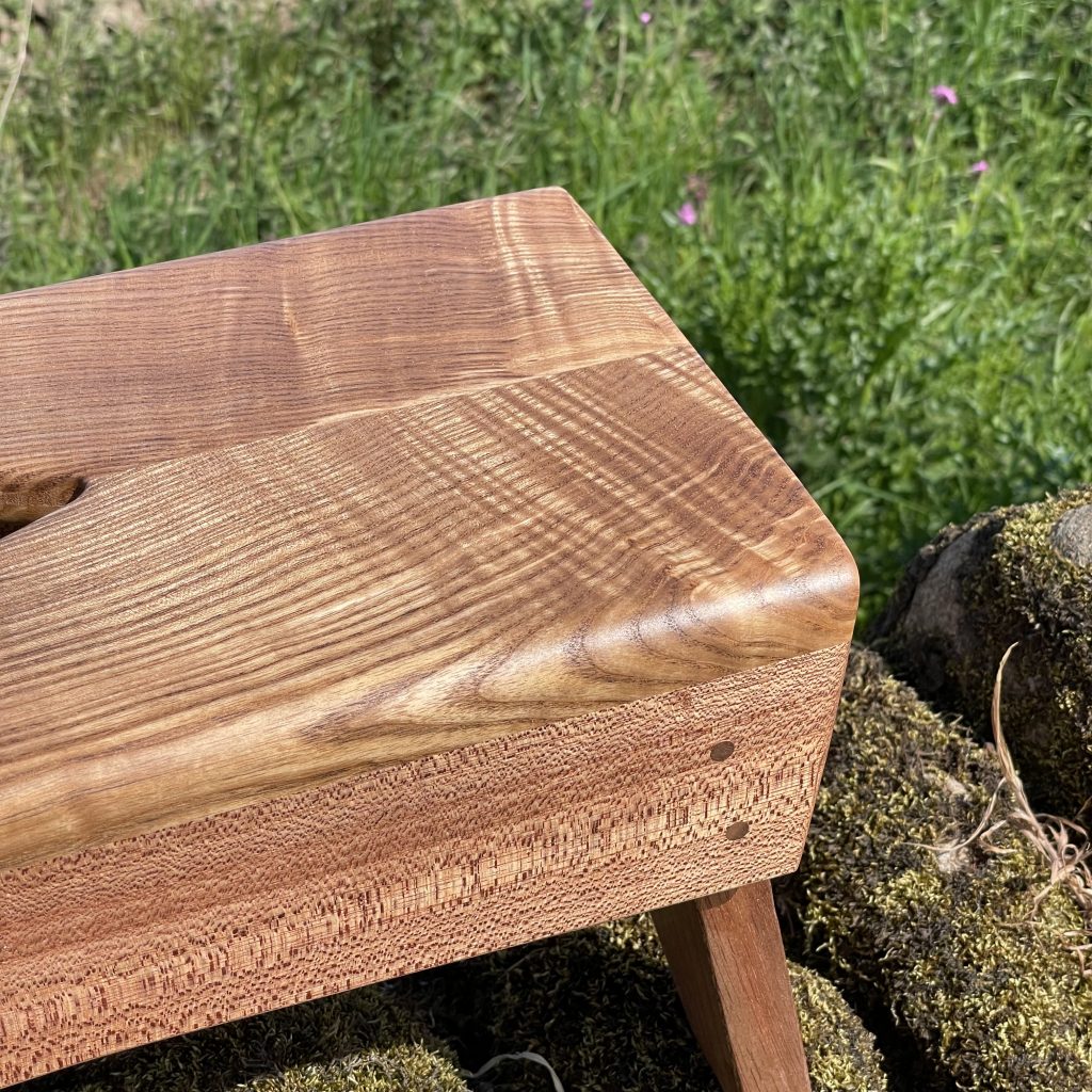 Scottish creepie stool in olive ash and sapele, made by Iain Stirling of Chapelhill Fine Furniture.